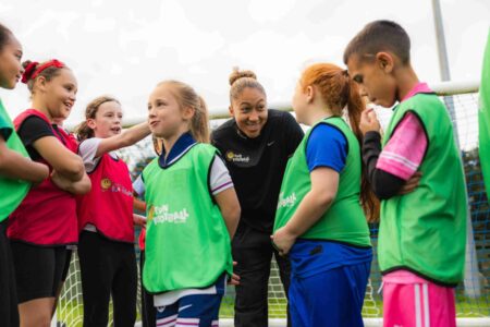 Football coach training kids